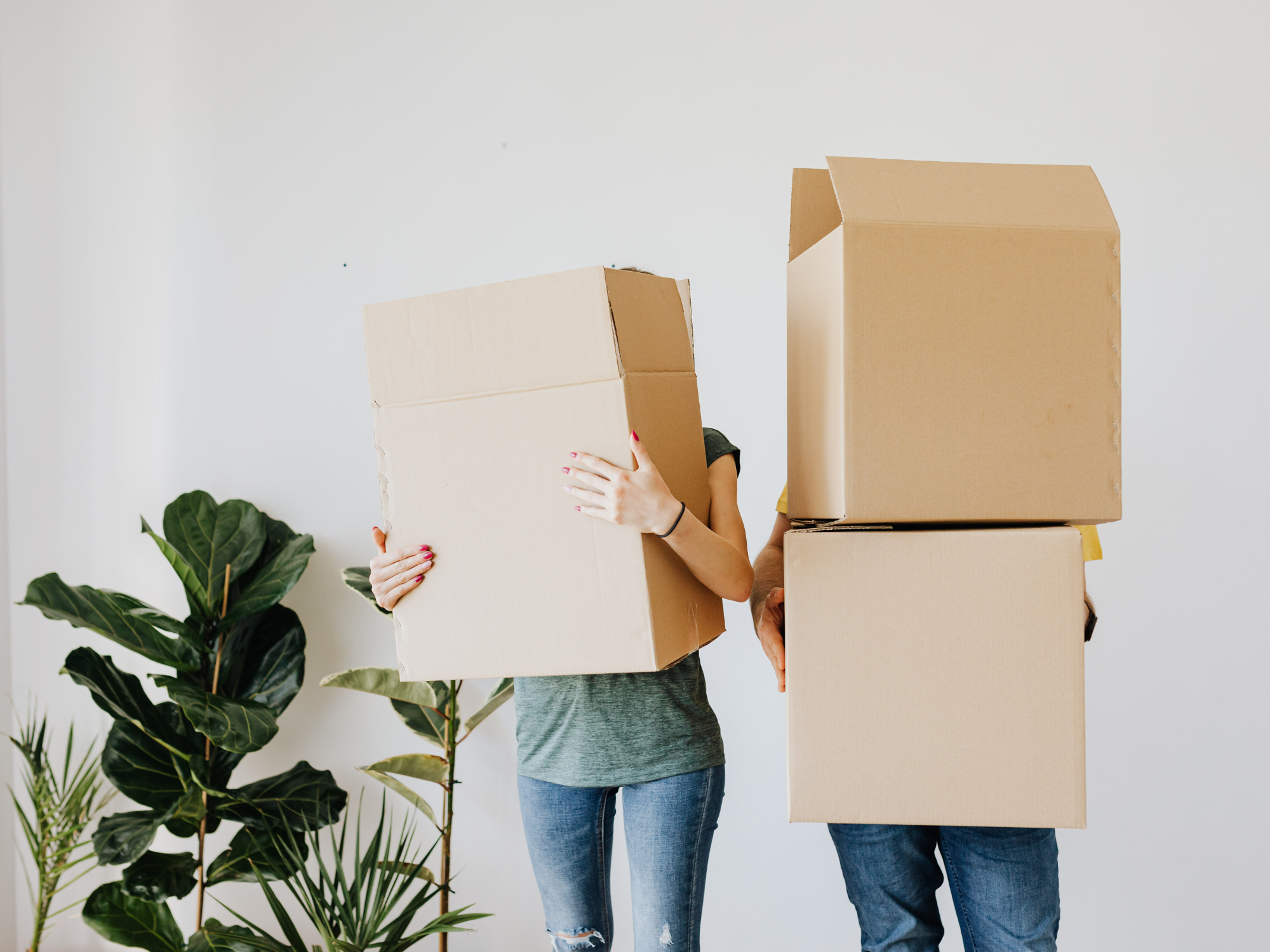 People carrying moving boxes into a storage unit at Secure Lock Self Storage in Lacombe, Alberta